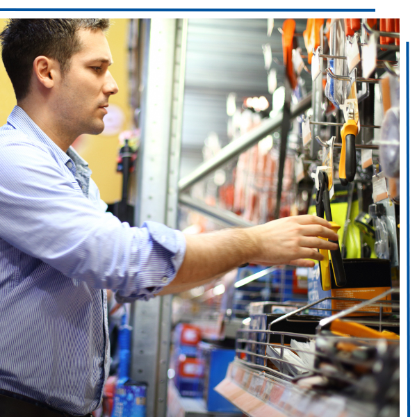 Man picking up a pair of pliers from a retail store wall display