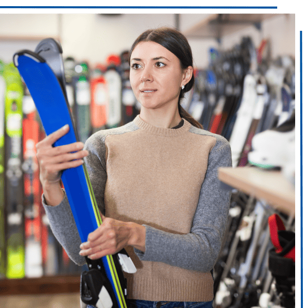 Woman holding skis in a sporting goods store